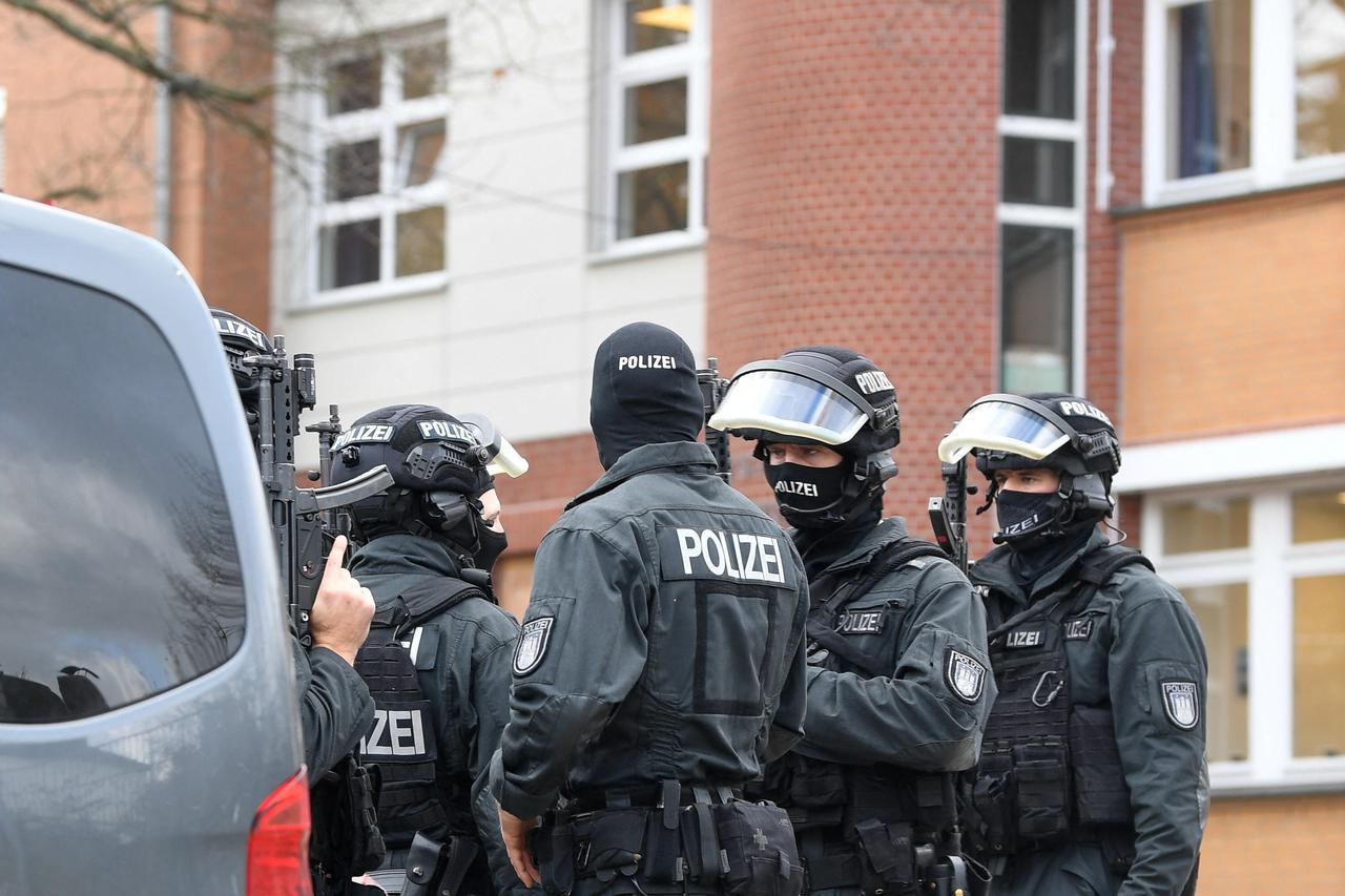 Police secure the area after local media said that two armed people had barricaded themselves in a classroom, in Hamburg