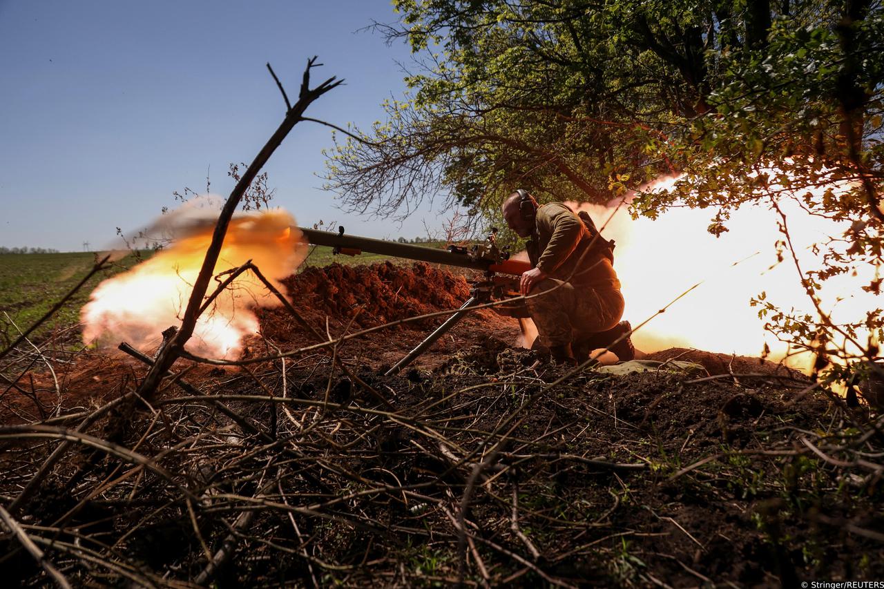 A Ukrainian service member fires an anti-tank grenade launcher at a front line near the city of Bakhmut