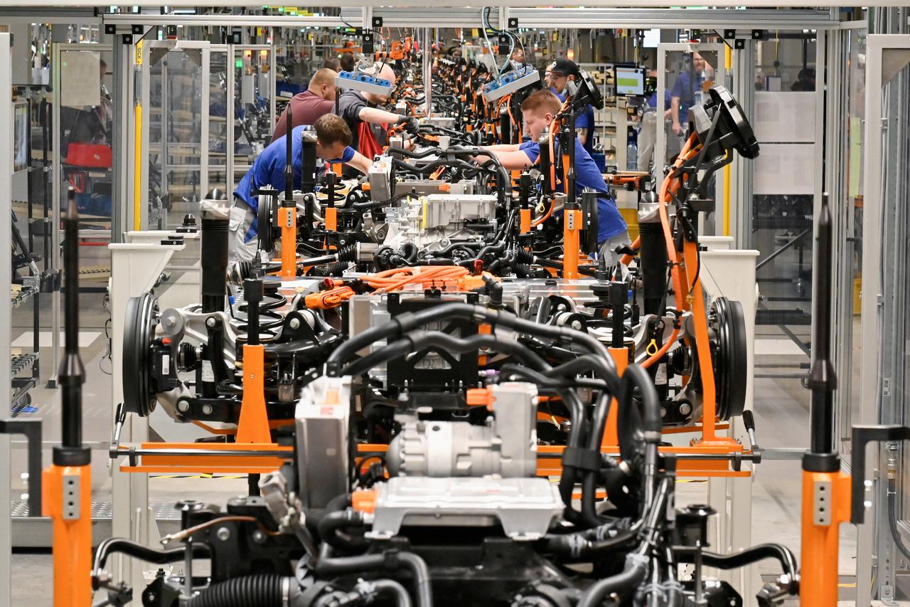 FILE PHOTO: Technicians work at the production line for electric car models of the Volkswagen Group, in Zwickau