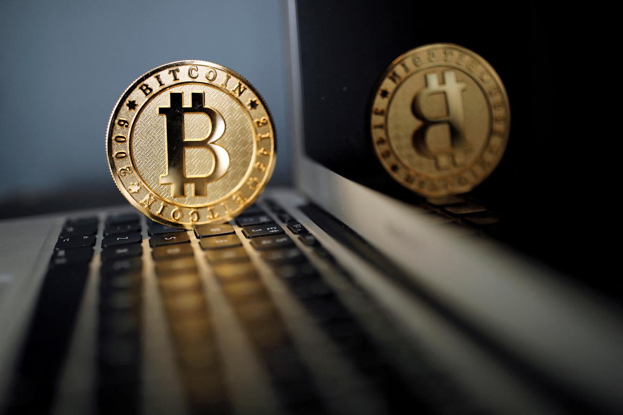 FILE PHOTO: A bitcoin is seen in an illustration picture taken at La Maison du Bitcoin in Paris