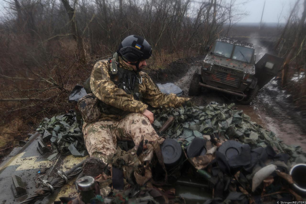 A Ukrainian service member rides atop of an infantry fighting vehicle near the frontline town of Bakhmut