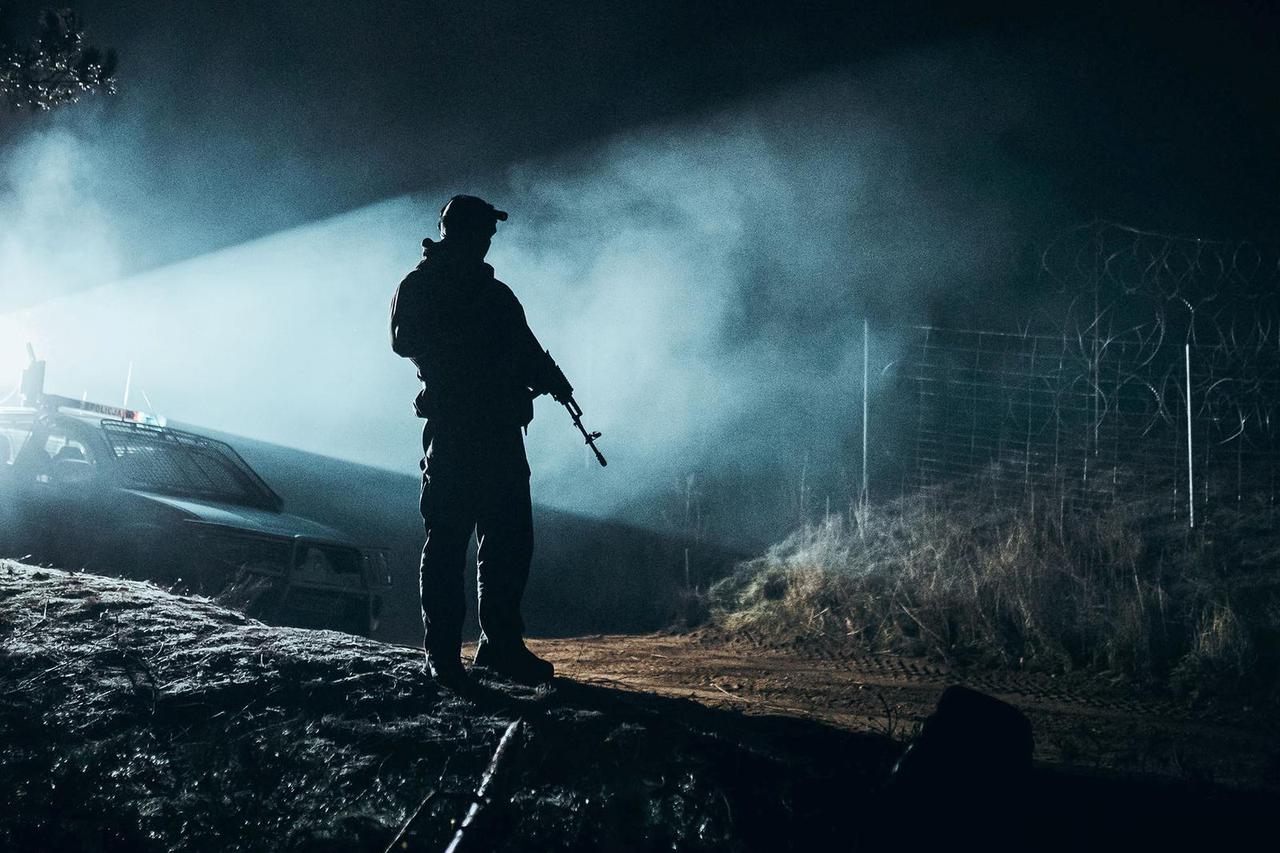 FILE PHOTO: A Polish soldier patrols Poland/Belarus border in Kuznica, Poland, in this photograph released by the Polish Defence Ministry