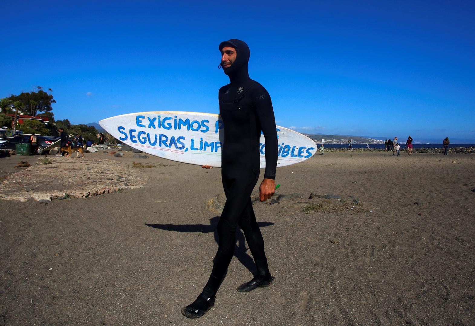 A local surfer walks on the beach as he takes part in a demonstration for the disappearance of foreign surfers in Ensenada after Mexican authorities said the parents of missing U.S. and Australian tourists arrived in Mexico to try to identify the dead bodies believed to be their children, in Ensenada, Mexico May 5, 2024. REUTERS/Jorge Duenes Photo: JORGE DUENES/REUTERS
