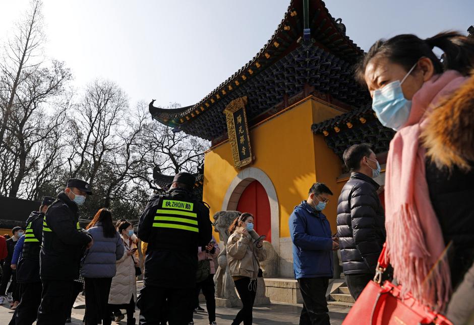 People visit a Buddhist temple on New Year’s Day in Wuhan