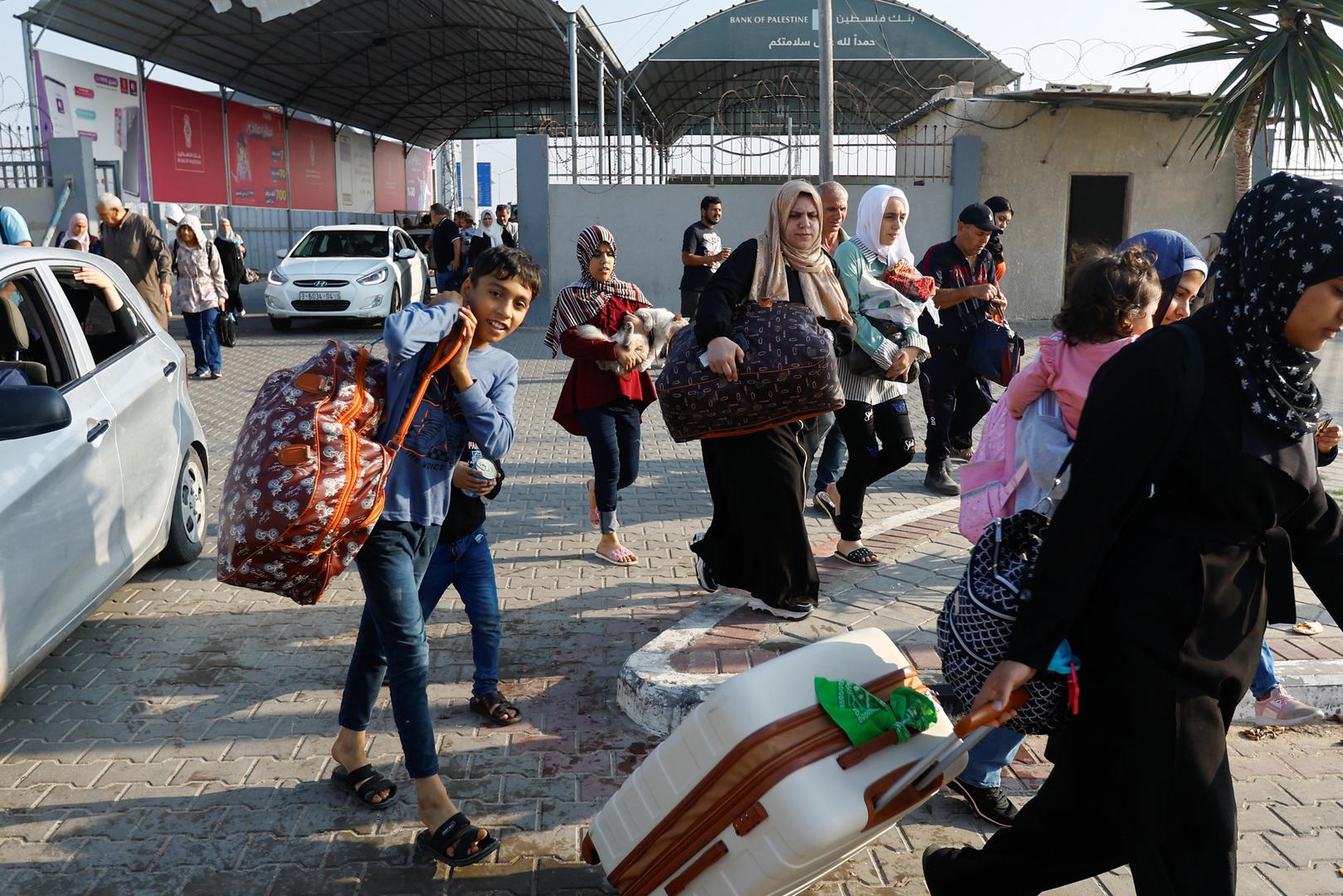 Palestinians with dual citizenship walk as they wait for permission to leave Gaza, amid the ongoing conflict between Israel and Palestinian Islamist group Hamas, at the Rafah border crossing with Egypt, in Rafah in the southern Gaza Strip, November 2, 2023. REUTERS/Ibraheem Abu Mustafa Photo: IBRAHEEM ABU MUSTAFA/REUTERS