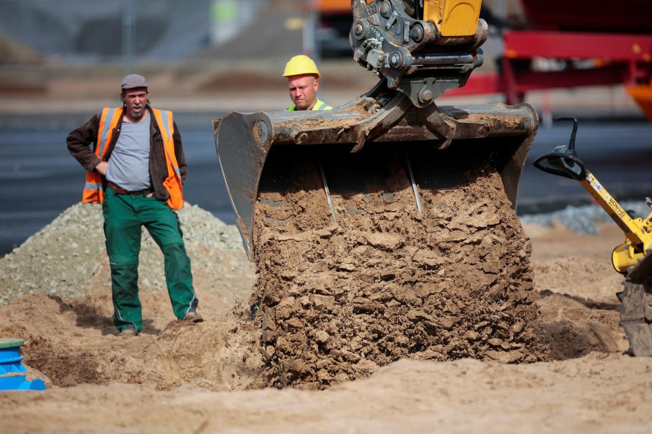 Workers are pictured at the construction site of the future Tesla Gigafactory, in Gruenheide