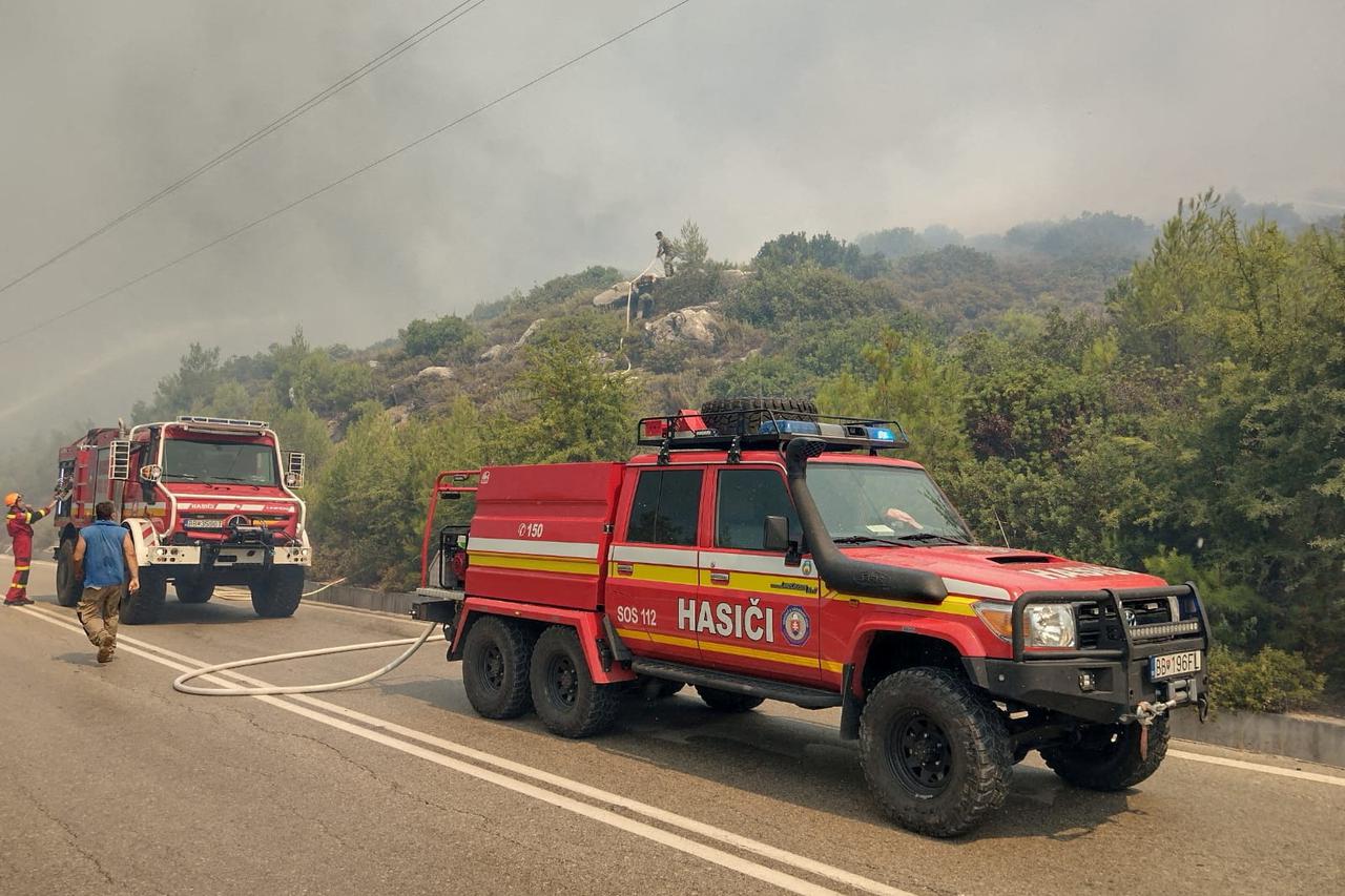 Firefighters try to extinguish a wildfire burning near Laerma, Rhodes Island
