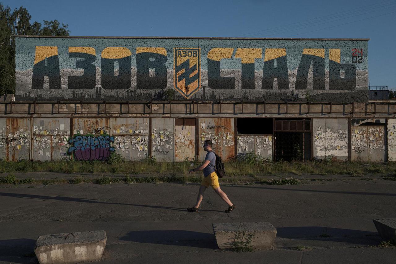 FILE PHOTO: A man walks past a mural painted in honour of the Azov Regiment in Kyiv