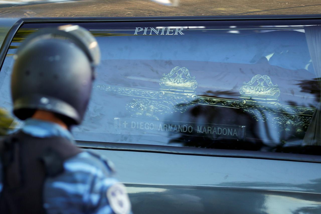 The car carrying the casket of soccer legend Diego Maradona arrives at the cemetery in Buenos Aires, Argentina