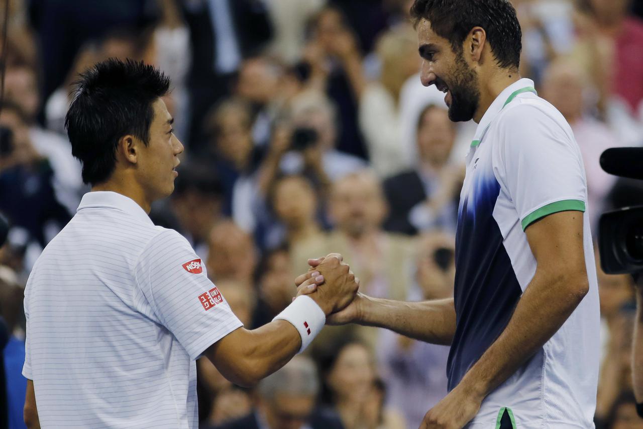 Marin Cilic of Croatia (R) shakes hands with Kei Nishikori of Japan after defeating him in the men's singles final match at the 2014 U.S. Open tennis tournament in New York, September 8, 2014.           REUTERS/Eduardo Munoz (UNITED STATES  - Tags: SPORT 
