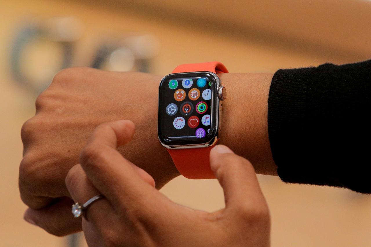 FILE PHOTO: An Apple Store employee shows the new Series 5 Apple Watch during the preview of the redesigned and reimagined Apple Fifth Avenue store in New York