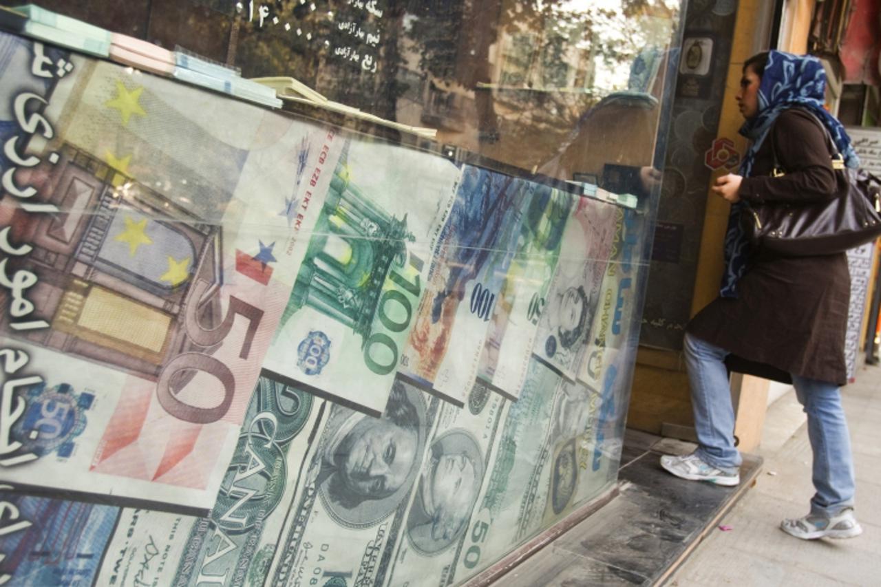 'EDITORS' NOTE: Reuters and other foreign media are subject to Iranian restrictions on leaving the office to report, film or take pictures in Tehran.     A woman enters a currency exchange shop in Te