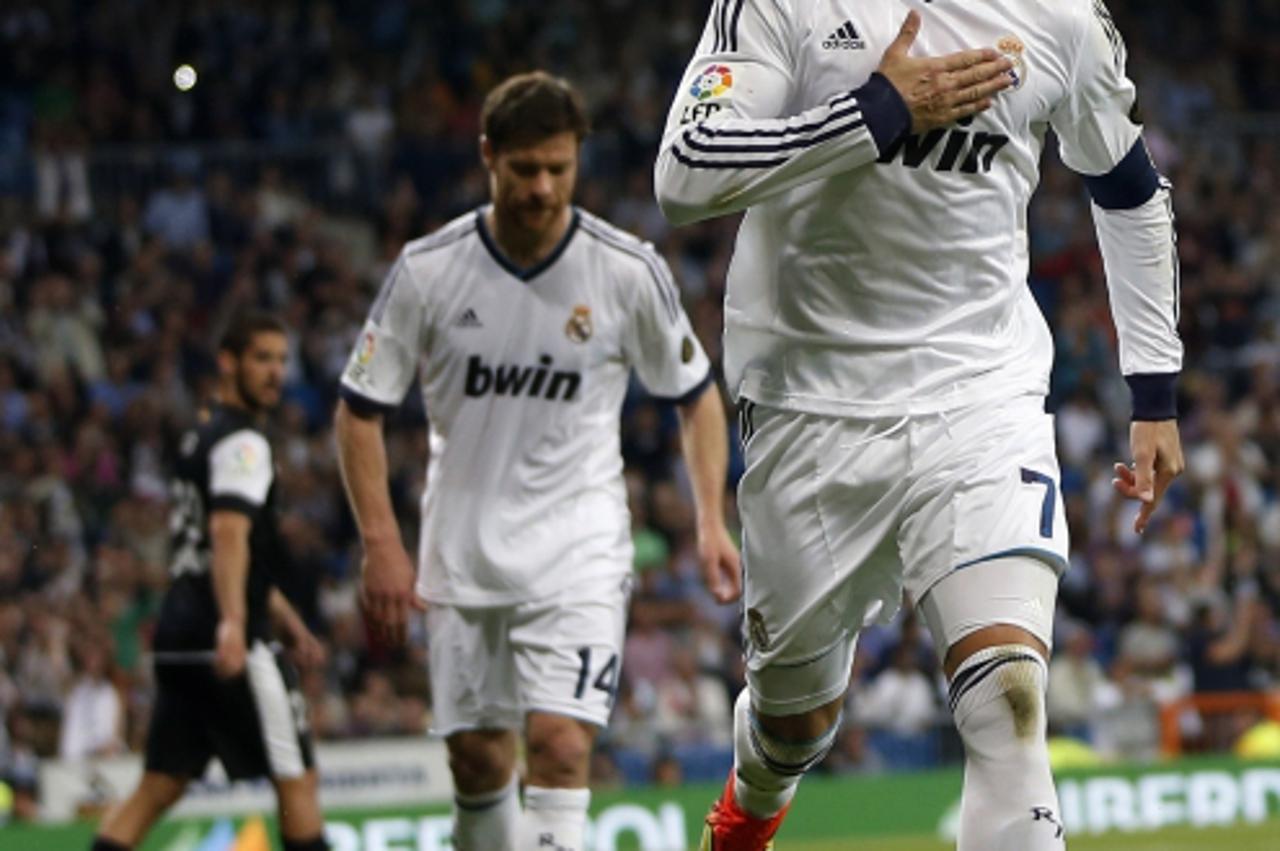 'Real Madrid\'s Cristiano Ronaldo celebrates his goal against Malaga during their Spanish first division soccer match at Santiago Bernabeu stadium in Madrid May 8, 2013. REUTERS/Susana Vera (SPAIN - T