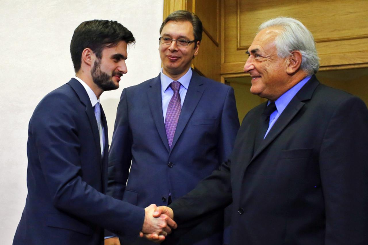 'Former International Monetary Fund (IMF) chief Dominique Strauss-Kahn (R), Serbia's Deputy Prime Minister Aleksandar Vucic (C) and Serbia's Finance Minister Lazar Krstic arrive for a meeting in the