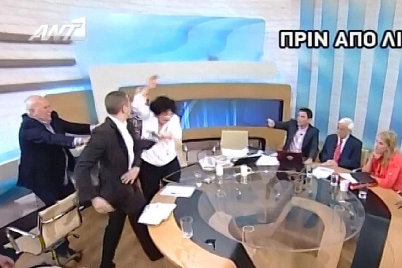 'epa03252376 A TV grab taken from Greek private Antenna television station, shows Elias Kassidiaris (2L), former MP and party press spokesman of Greek far-ight Chryssi Avghi (Golden Dawn) party, slapp