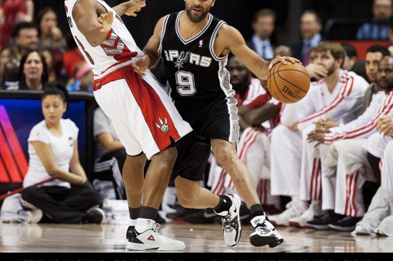 'Toronto Raptors\' Kyle Lowry, left, defends San Antonio Spurs\' Tony Parker (9) during the first half of an NBA basketball game, Sunday, Nov. 25, 2012, in Toronto. (AP Photo/The Canadian Press, Aaron