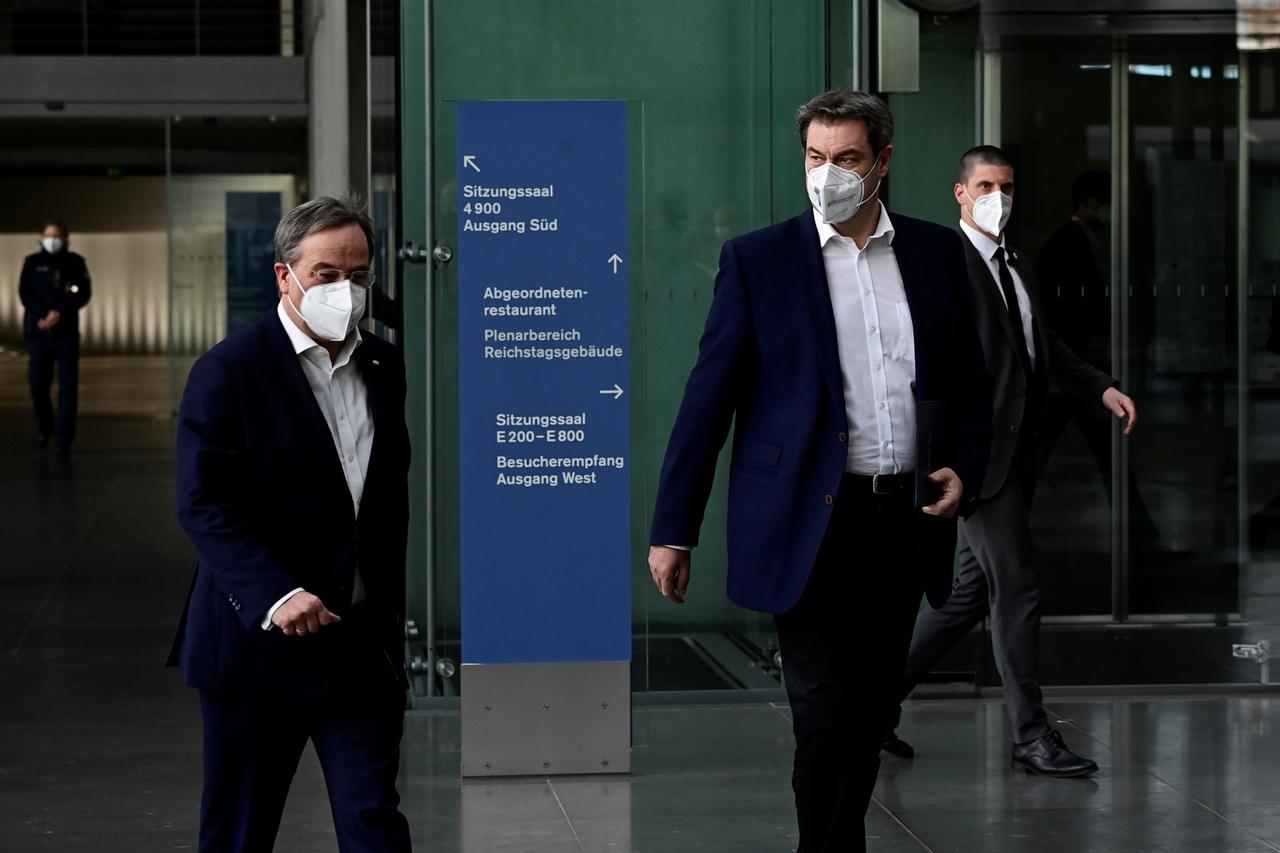 Armin Laschet and Markus Soder walk after a news conference in Berlin