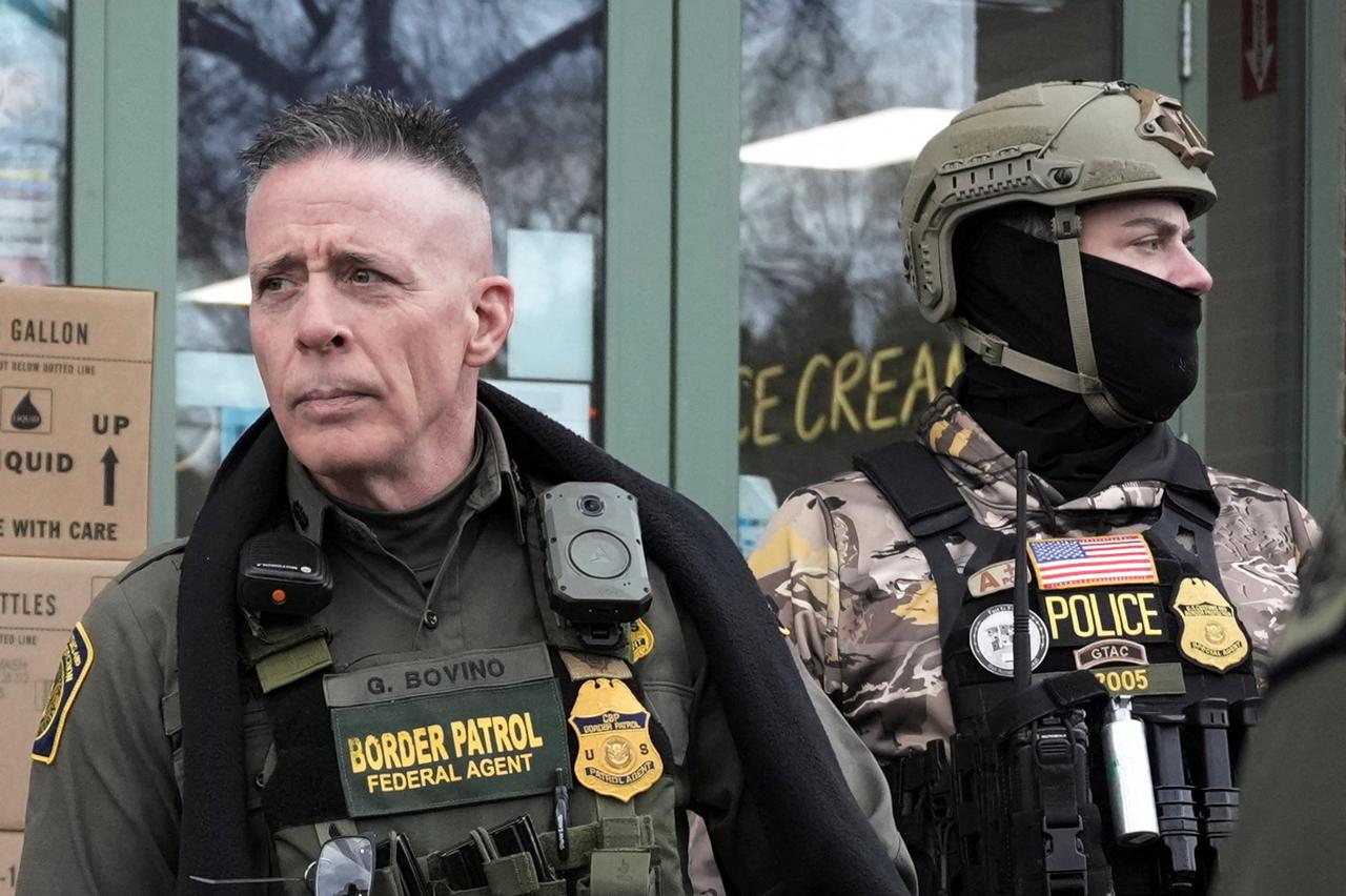 Border Patrol commander Greg Bovino's convoy stops at a gas station in Columbia Heights