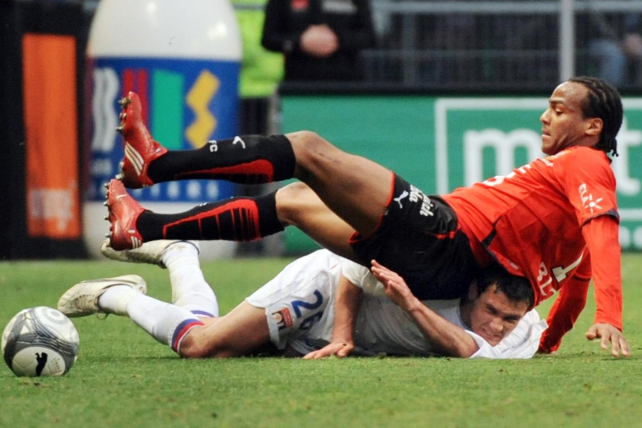 'Renne\'s forward Jimmy Briand (Up) vies with Lyon\'s defender Dejan Lovren during their French L1 football match Rennes vs Lyon, on April 03, 2010, at the route de Lorient stadium in Rennes. AFP PHOT
