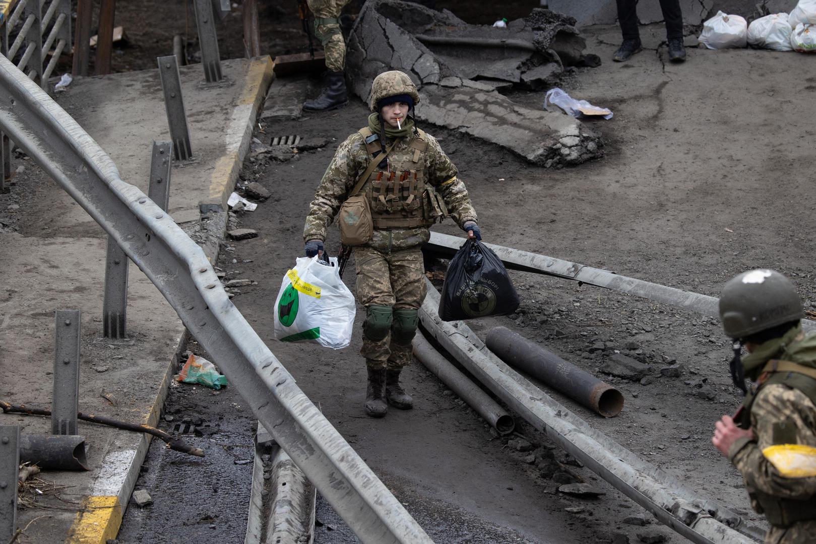 Soldiers help people cross a destroyed bridge as they evacuate the city of Irpin, northwest of Kyiv, during heavy shelling and bombing on March 5, 2022, 10 days after Russia launched a military invasion on Ukraine. Photo by Raphael Lafargue/ABACAPRESS.COM
