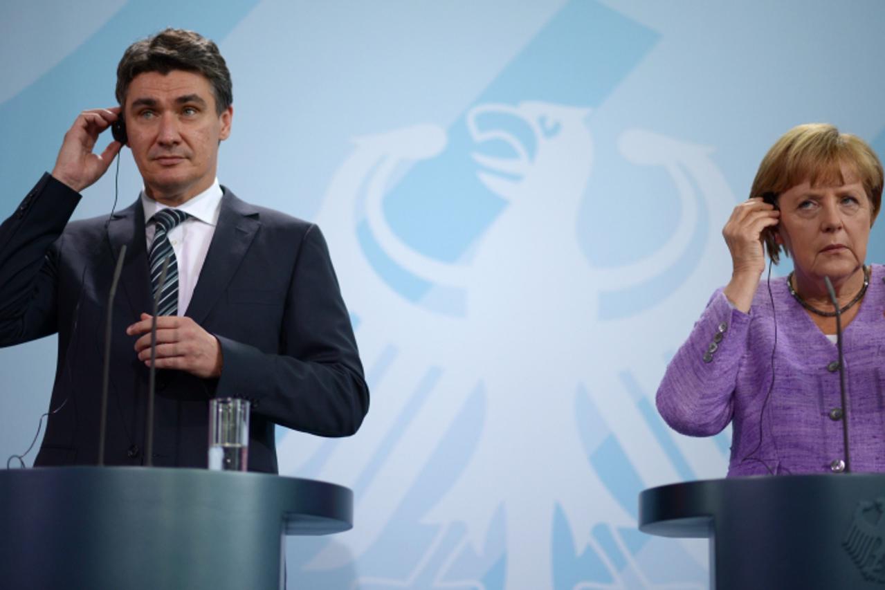 'German Chancellor Angela Merkel and Croatian Prime Minister Zoran Milanovic address a press conference at the Chancellery in Berlin on September 19, 2012.   AFP PHOTO / JOHANNES EISELE  '