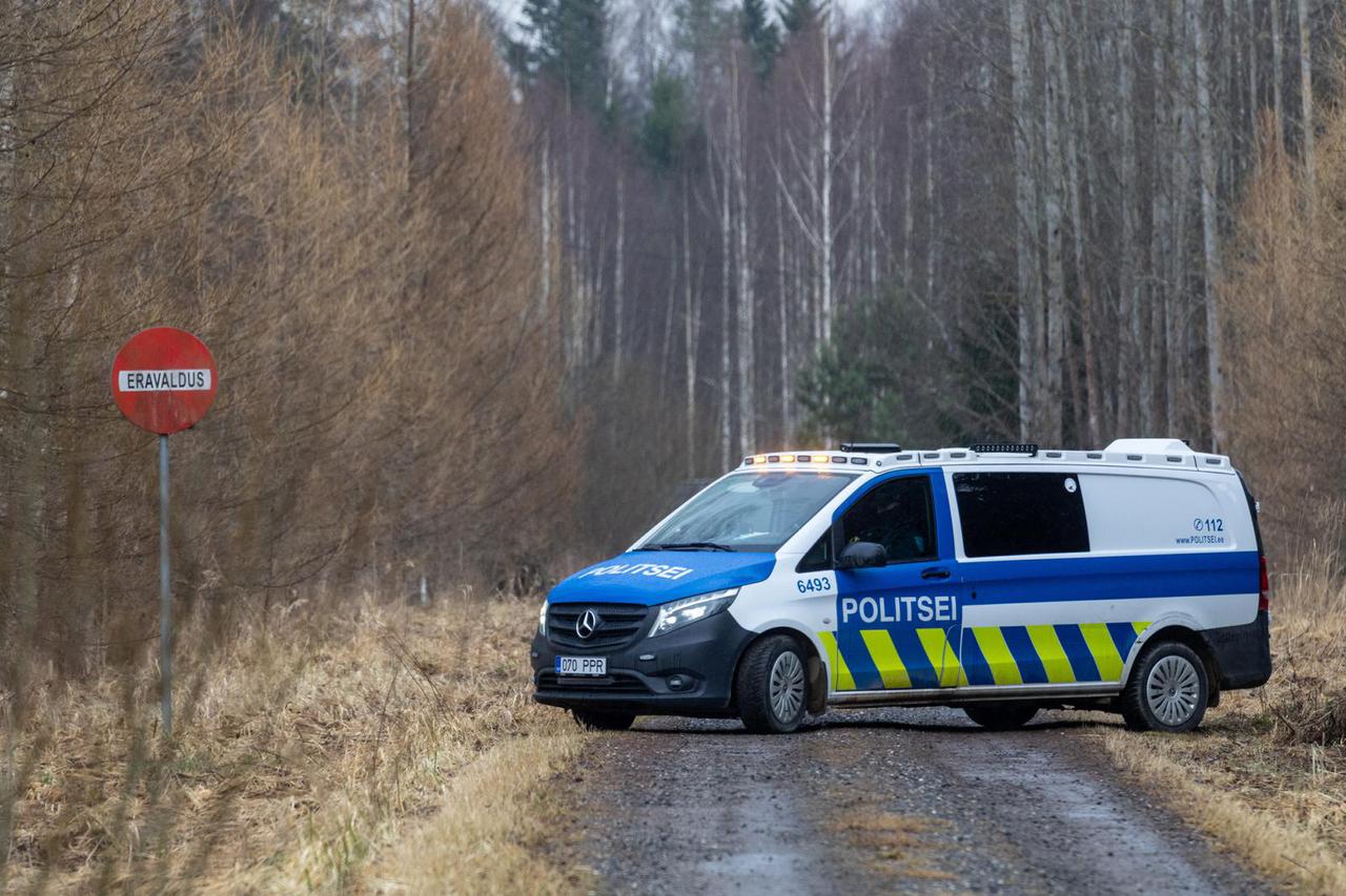 A vehicle stands on the road near the site where debris from at least one drone was found, in Kastre Parish