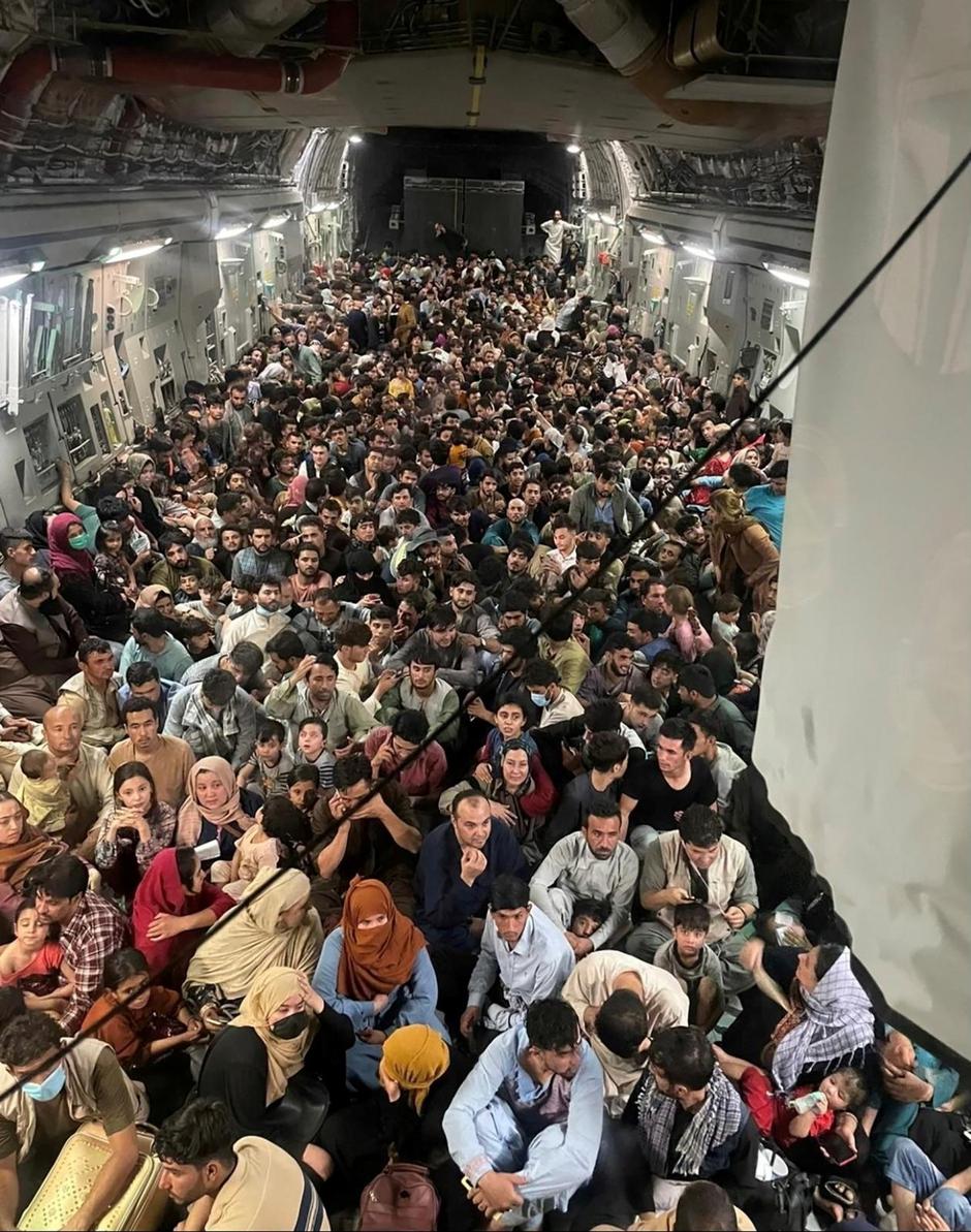 Afghan evacuees crowd the interior of a U.S. Air Force C-17 Globemaster III transport aircraft flying from Kabul