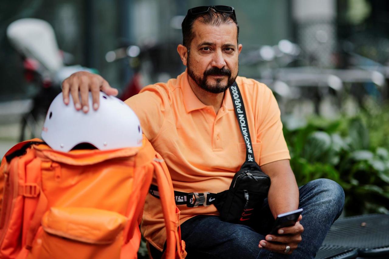 Former Afghan Communication Minister Sadaat works as a bicycle rider for the food delivery service Lieferando in Leipzig