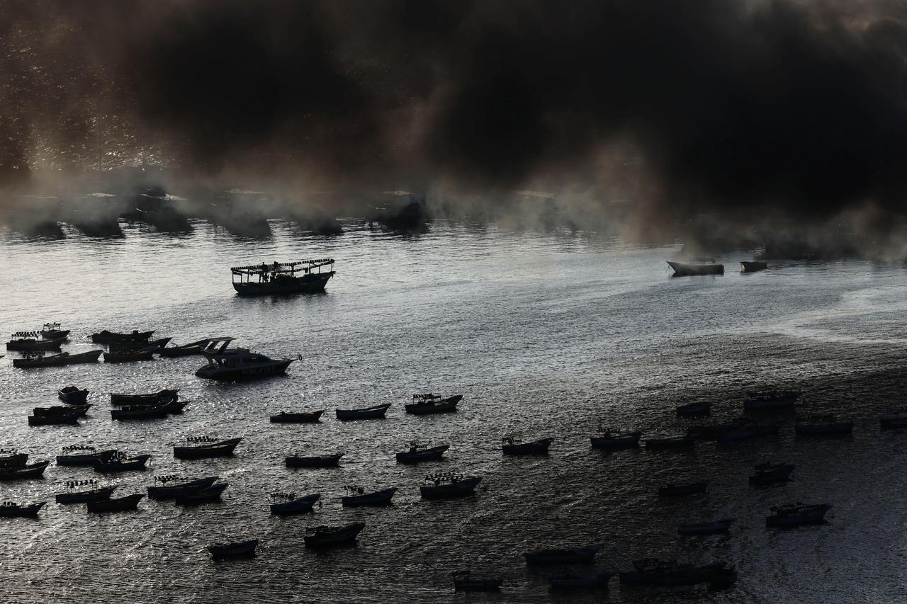 Smoke rises from Israeli strikes as rockets are fired from Gaza towards Israel