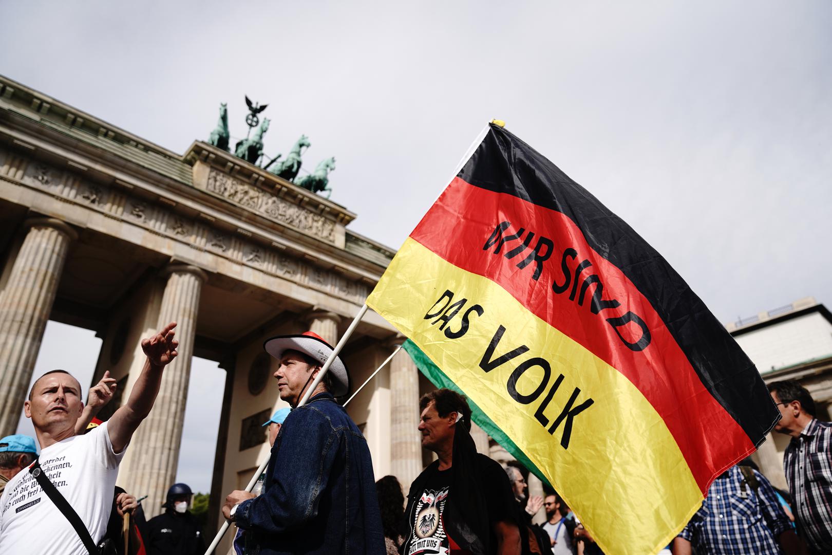 29 August 2020, Berlin: A participant of a demonstration against the Corona measures holds a German flag with the writing "We are the people". Photo: Kay Nietfeld/dpa /DPA/PIXSELL