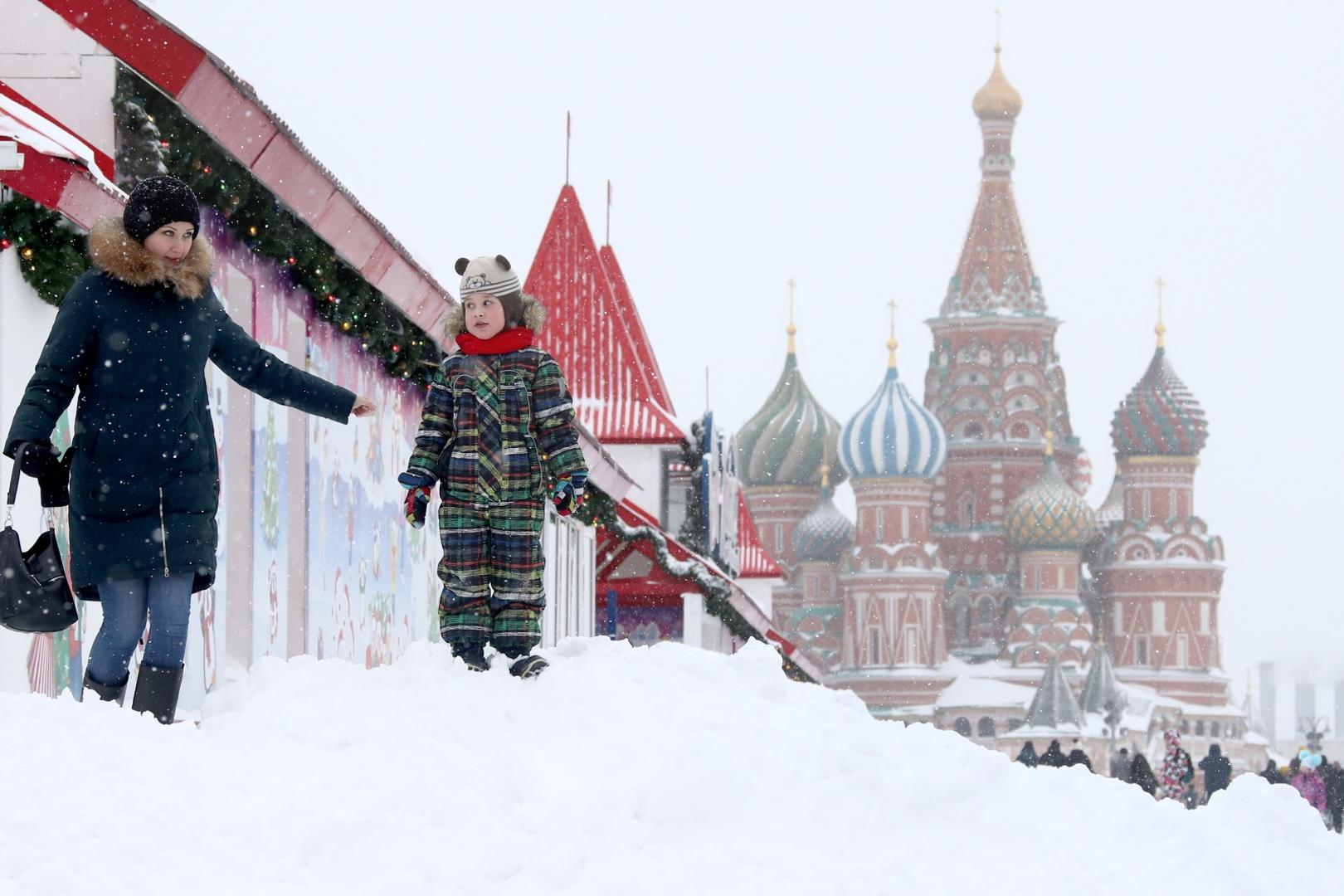 MOSCOW, RUSSIA - FEBRUARY 13, 2021: A woman and a child walk in Moscow's Red Square during a snowfall. Valery Sharifulin/TASS
 Photo via Newscom Newscom/PIXSELL