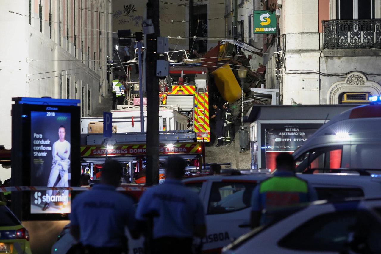 First responders work at the site of a funicular accident in Lisbon