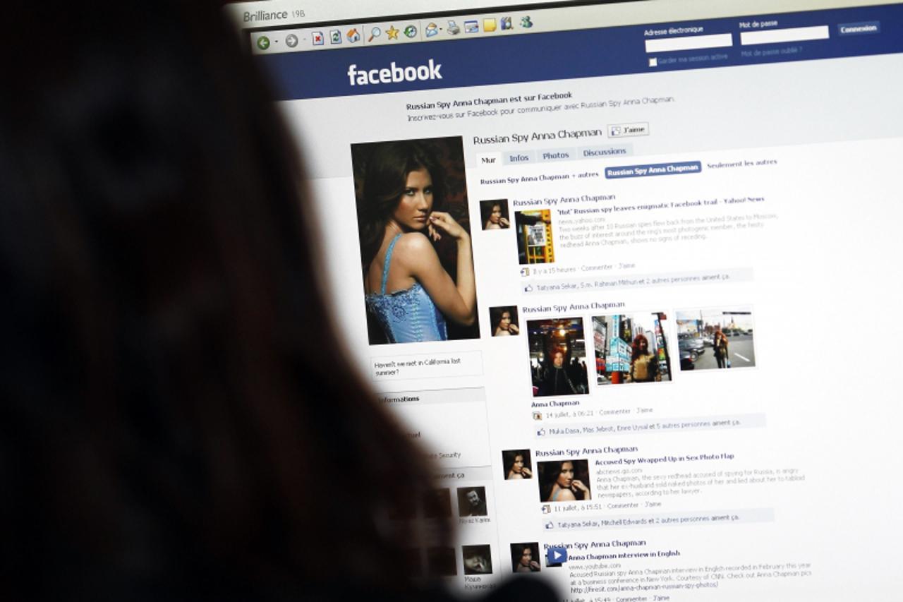 'An internet user looks at a facebook page dedicated to Anna Chapman in Paris on July 23, 2010. Two weeks after 10 Russian spies flew back from the United States to Moscow, the buzz of interest around