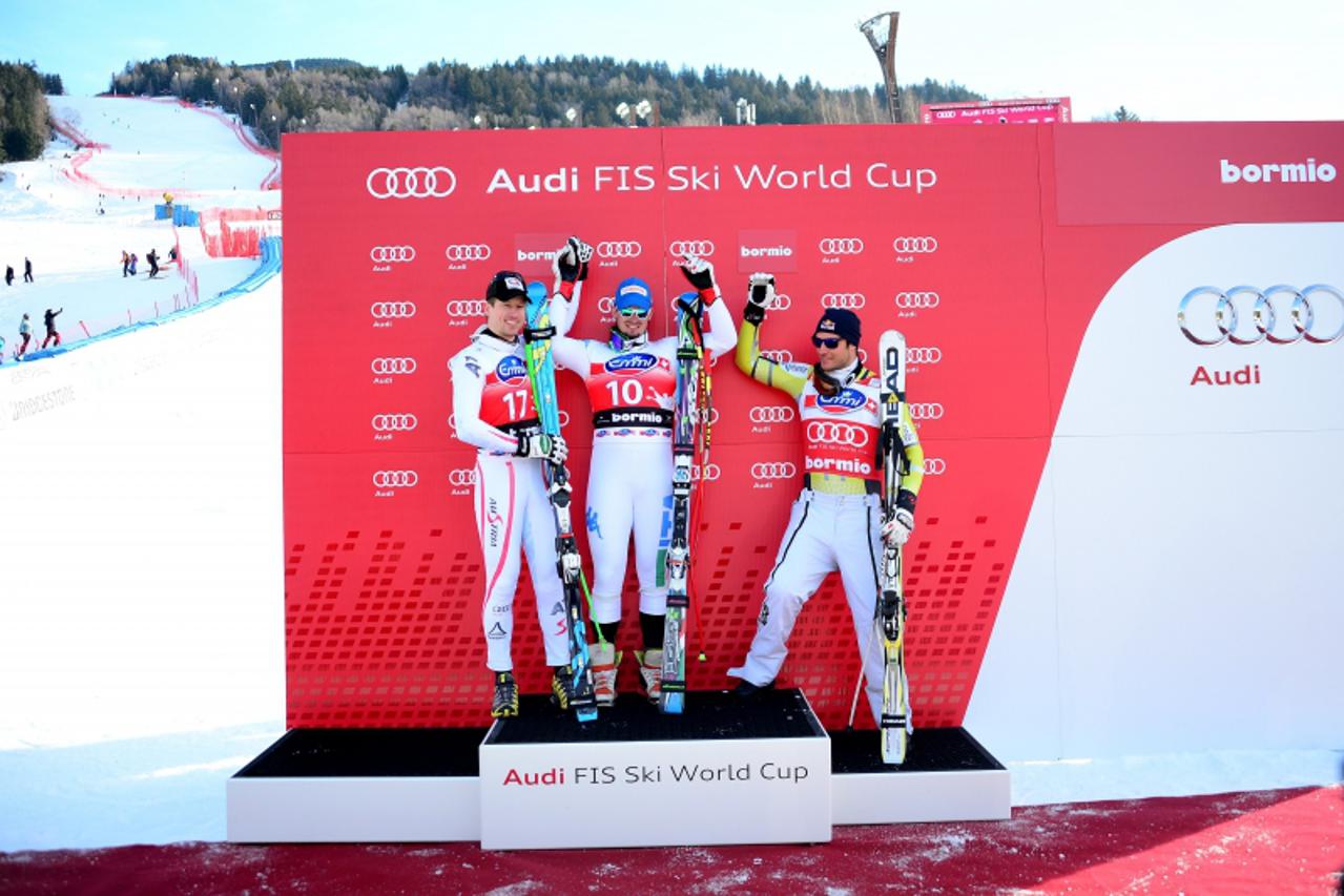 'Italy's Dominik Paris (C) and Austria's Hannes Reichelt (L), who were tied for the first place, celebrate victory alongside Norway's Aksel Lund Svindal who came in third, after the Men's World cu