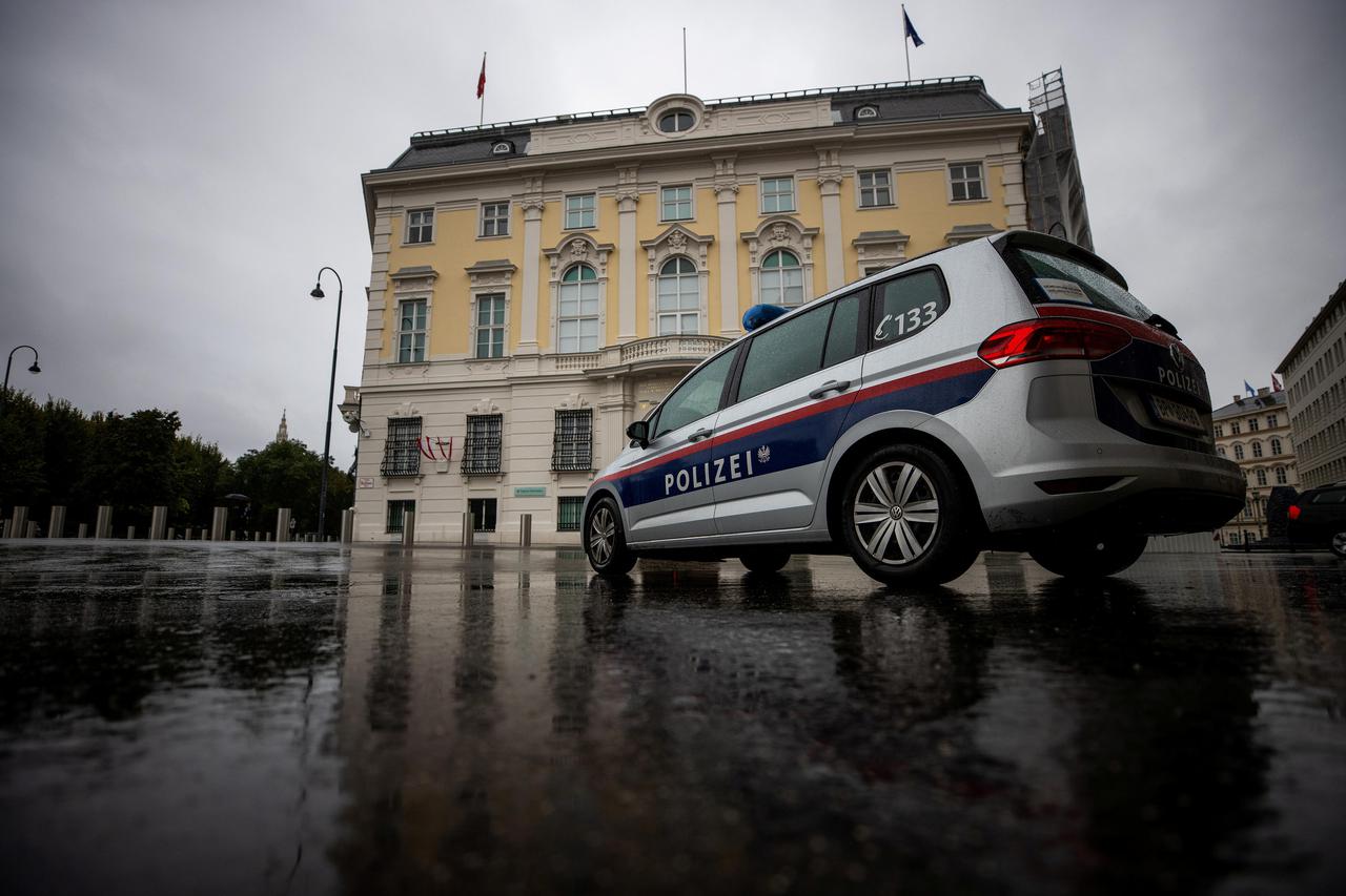 Police car parks in front of the Austrian federal chancellery, in Vienna