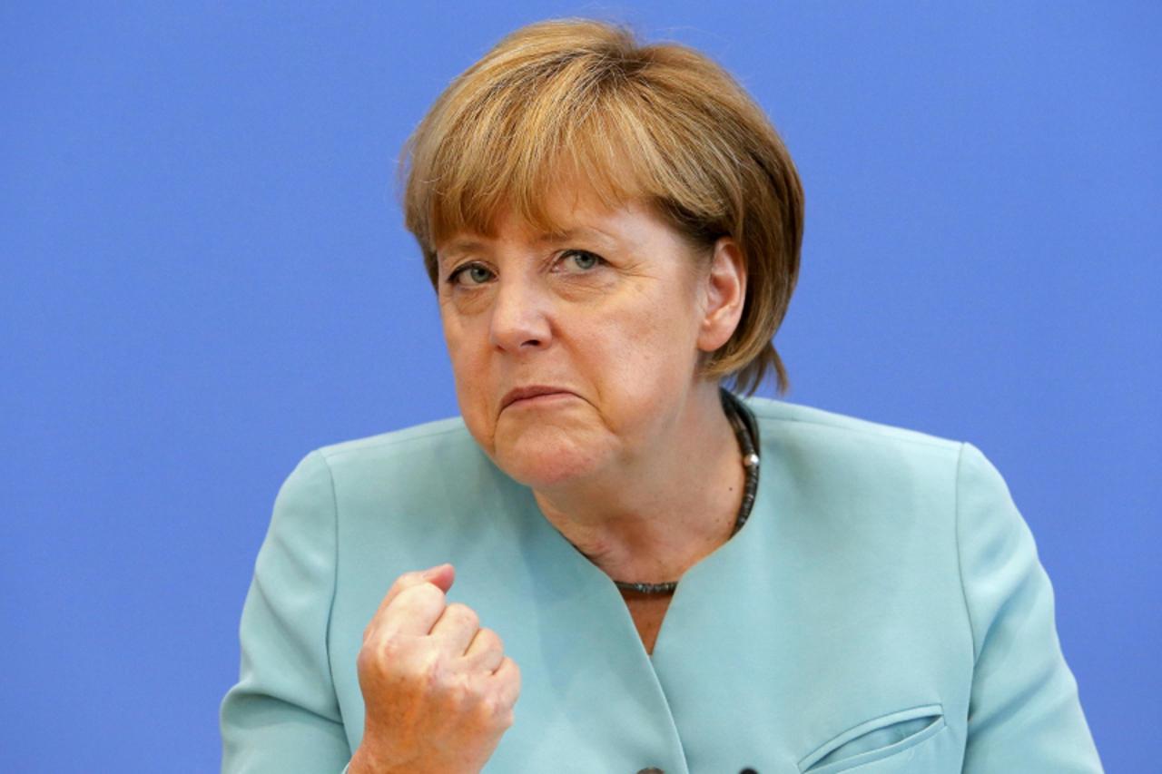 'German Chancellor Angela Merkel gestures as she address media during a news conference at Bundespressekonferenz in Berlin July 19, 2013.  REUTERS/Tobias Schwarz (GERMANY  - Tags: POLITICS)'