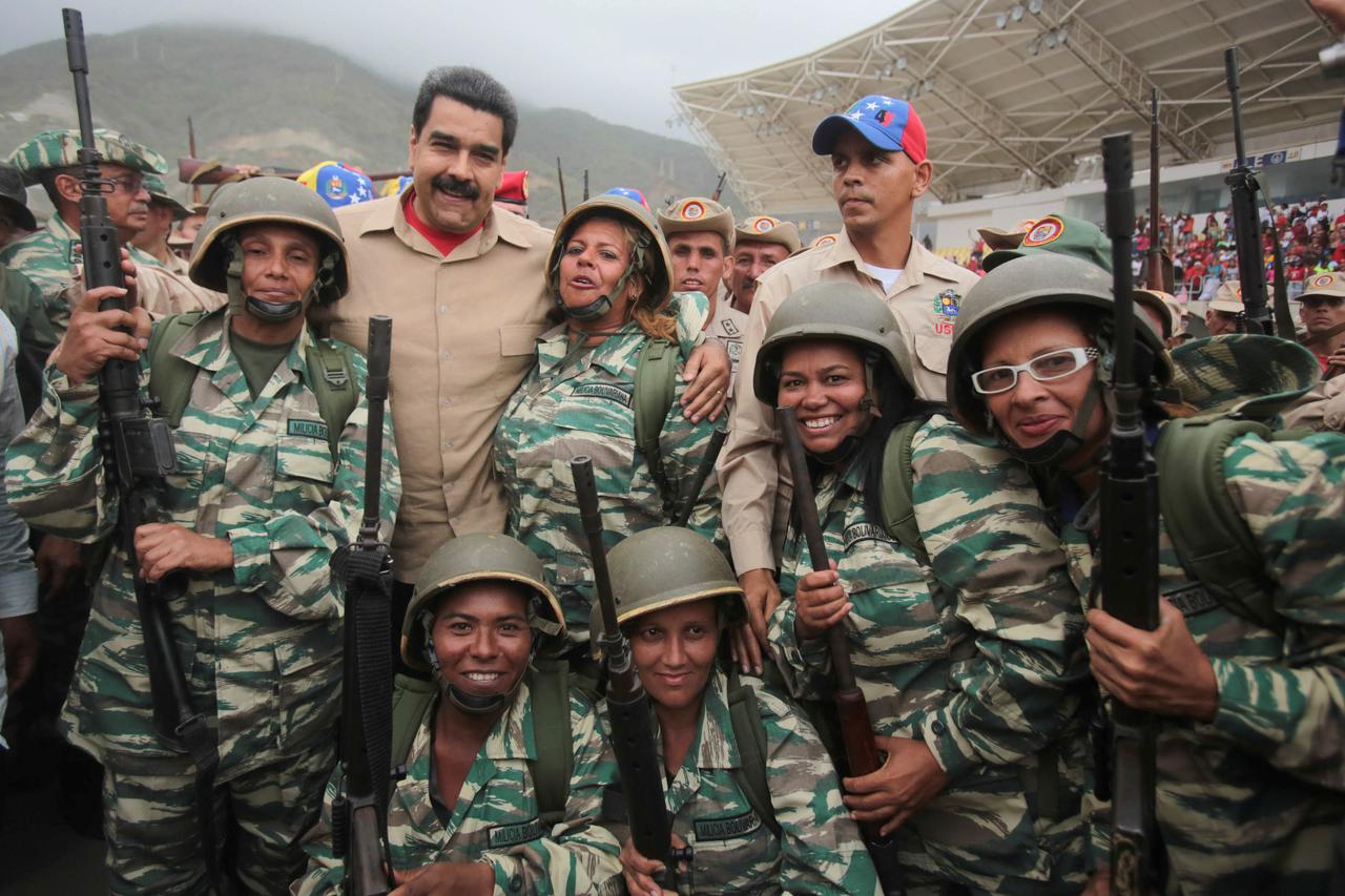 Venezuela's President Nicolas Maduro (back row 2nd L) poses for a photo with militia members during a military parade in La Guaira, Venezuela May 21, 2016. Miraflores Palace/Handout via REUTERS ATTENTION EDITORS - THIS PICTURE WAS PROVIDED BY A THIRD PART