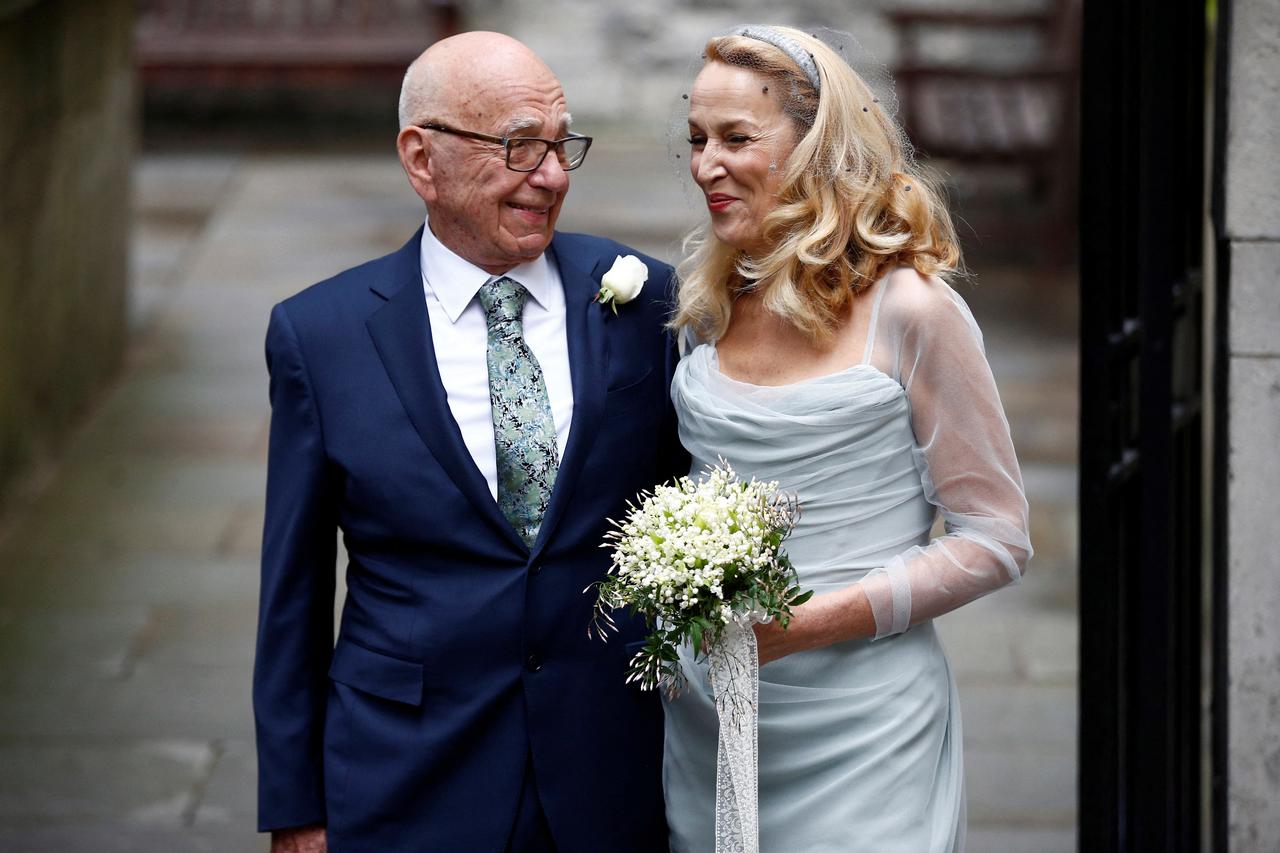 FILE PHOTO: Media Mogul Rupert Murdoch and former supermodel Jerry Hall pose for a photograph outside St Bride's church following a service to celebrate their wedding which took place on Friday, in London