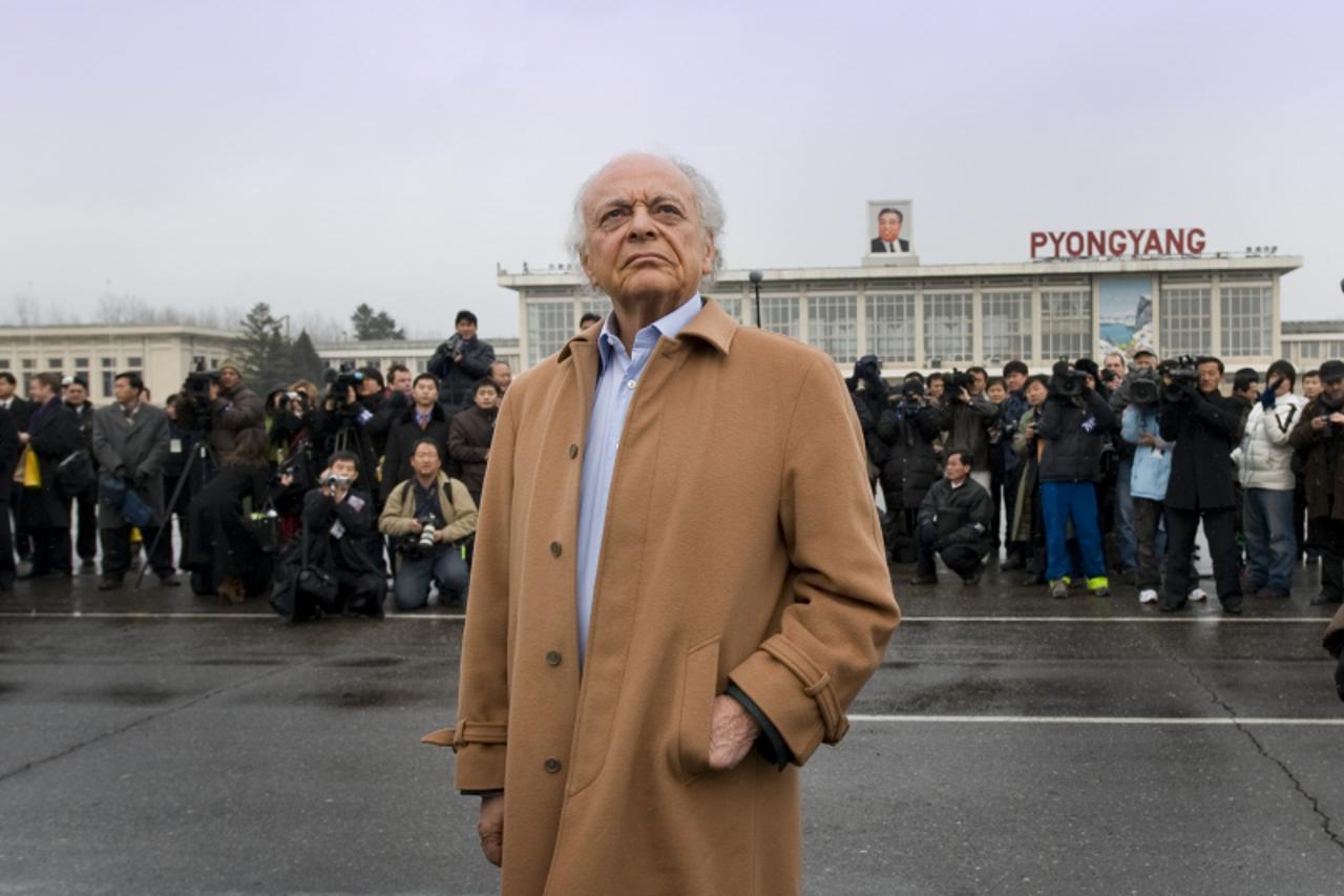 'NY Philharmonic Music Director Lorin Maazel on the tramac at Pyongyang\'s airport waiting for his orchestra to deplane. Feb. 25, 2008'