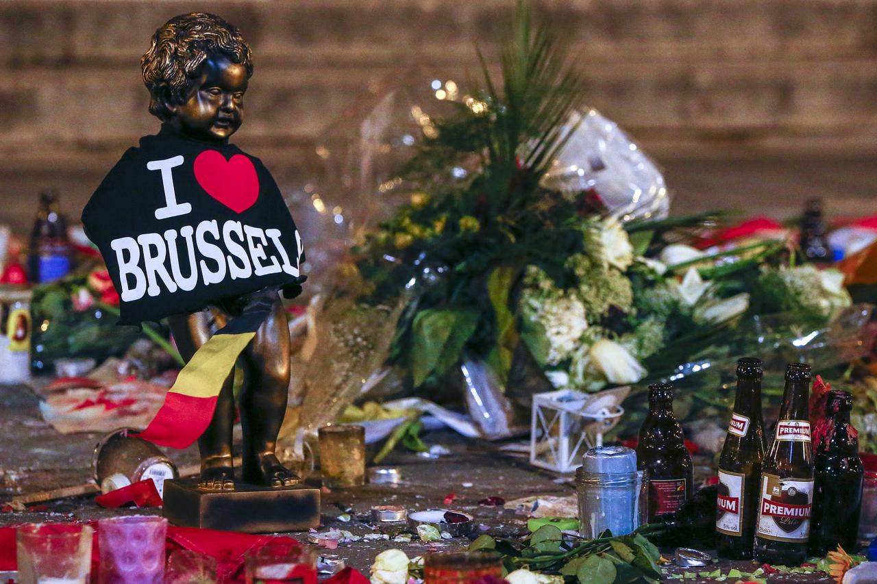 A replica of the Manneken-Pis statue, a major Brussels tourist attraction, is seen among flowers at a memorial for the victims of bomb attacks in Brussels metro and Brussels international airport of Zaventem, in Brussels, Belgium, March 28, 2016.   REUTER