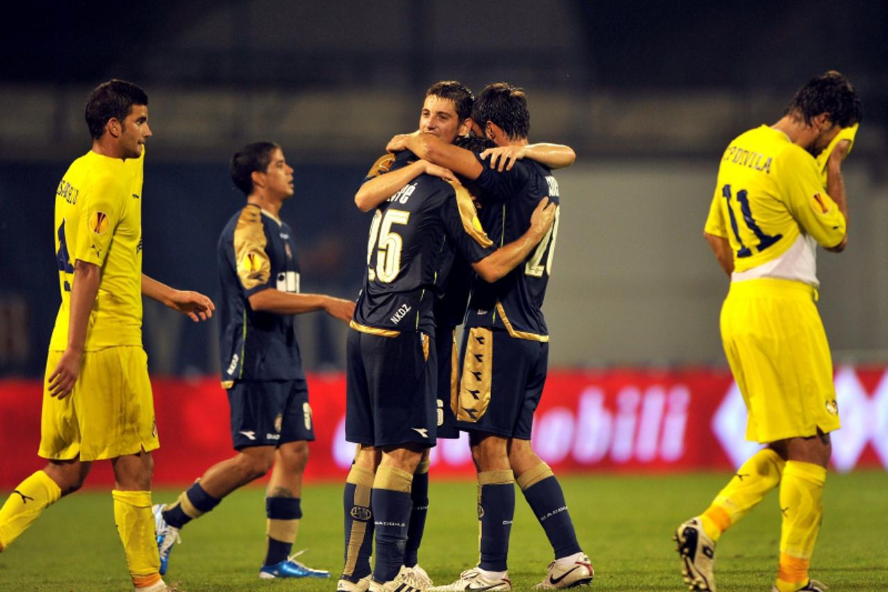 \'Dinamo\'s players (C) celebrate next to players of Villarreal (L and R) after their Europa League Group D football match in Zagreb, Croatia on September 16, 2010. Dinamo won 2-0.    AFP PHOTO/ HRVOJ