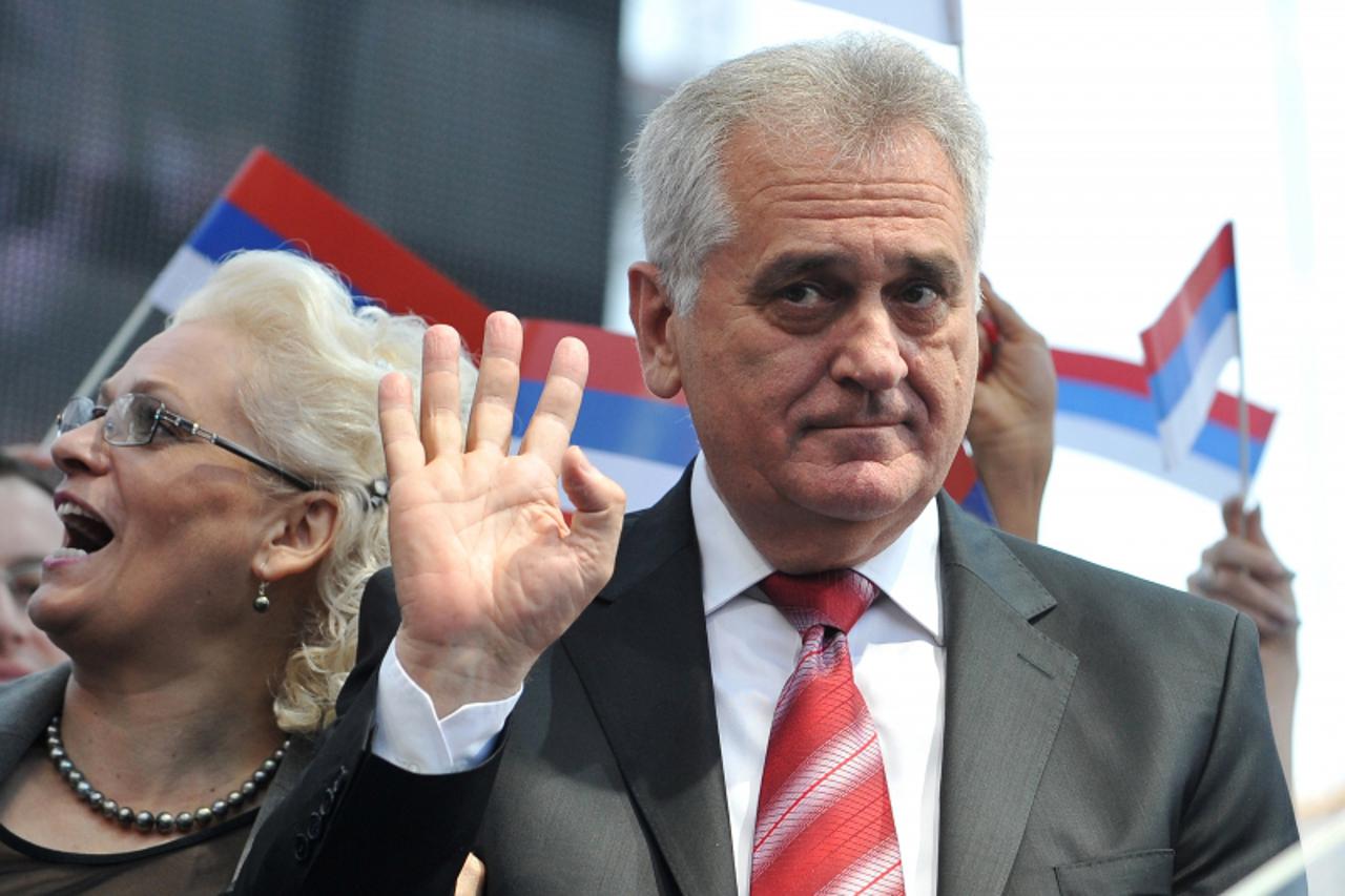 'Leader of Serbian Progressive Party  (SNS) Tomislav Nikolic waves to his supporters during a rally in Belgrade on April 26, 2012. More than 10,000 supporters gathered for the rally of the Serbian mai