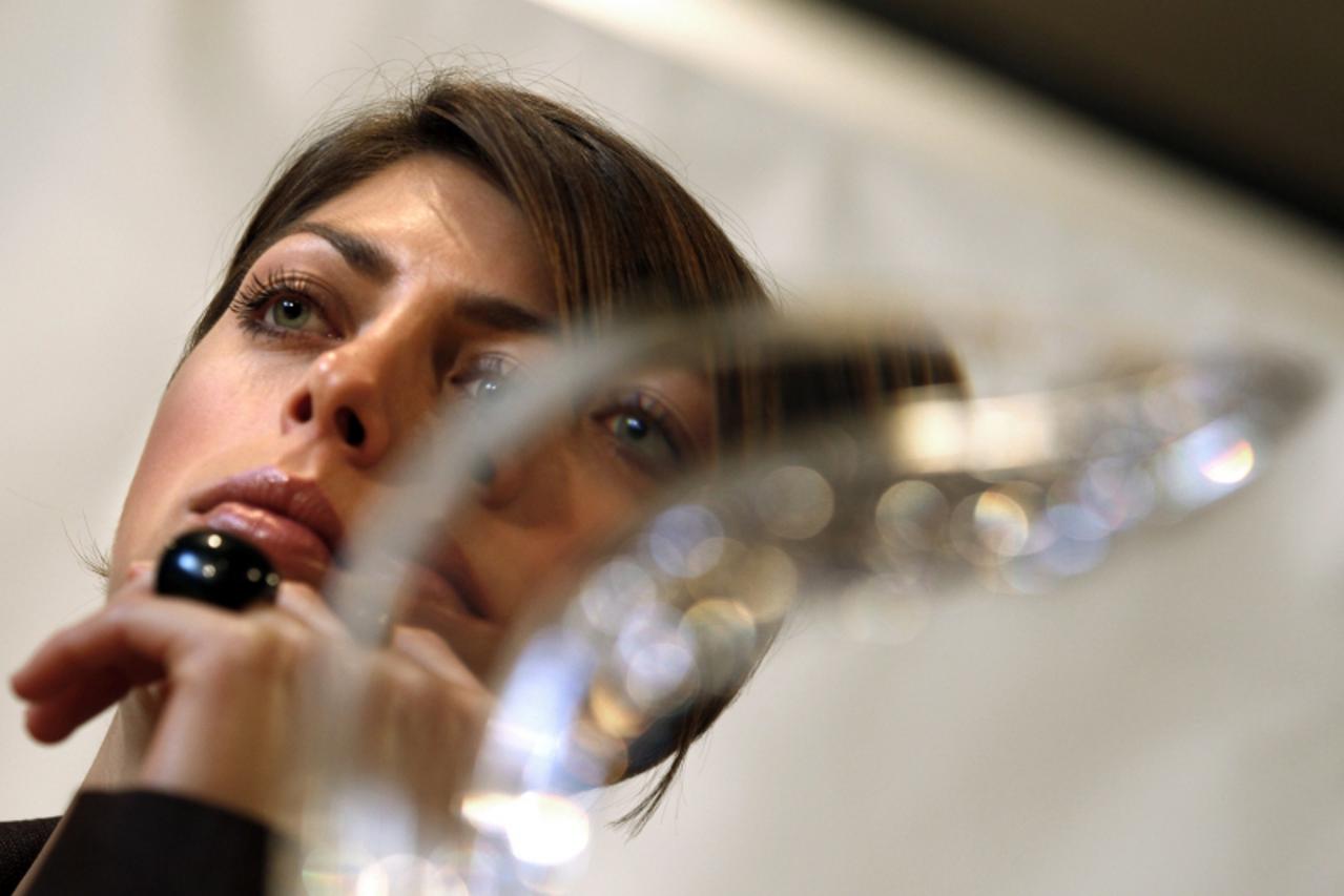 \'World indoor high jump champion Blanka Vlasic of Croatia is seen through her IAAF Athlete of the Year award during a news conference in Monte Carlo November 21, 2010. Kenyan 800 metres runner David 