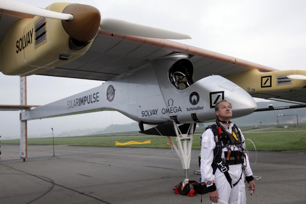 'Solar Impulse project CEO and pilot Andre Borschberg looks at the sky before take off at Payerne airport May 24, 2012. The Solar Impulse HB-SIA prototype aircraft, which has 12,000 solar cells built 