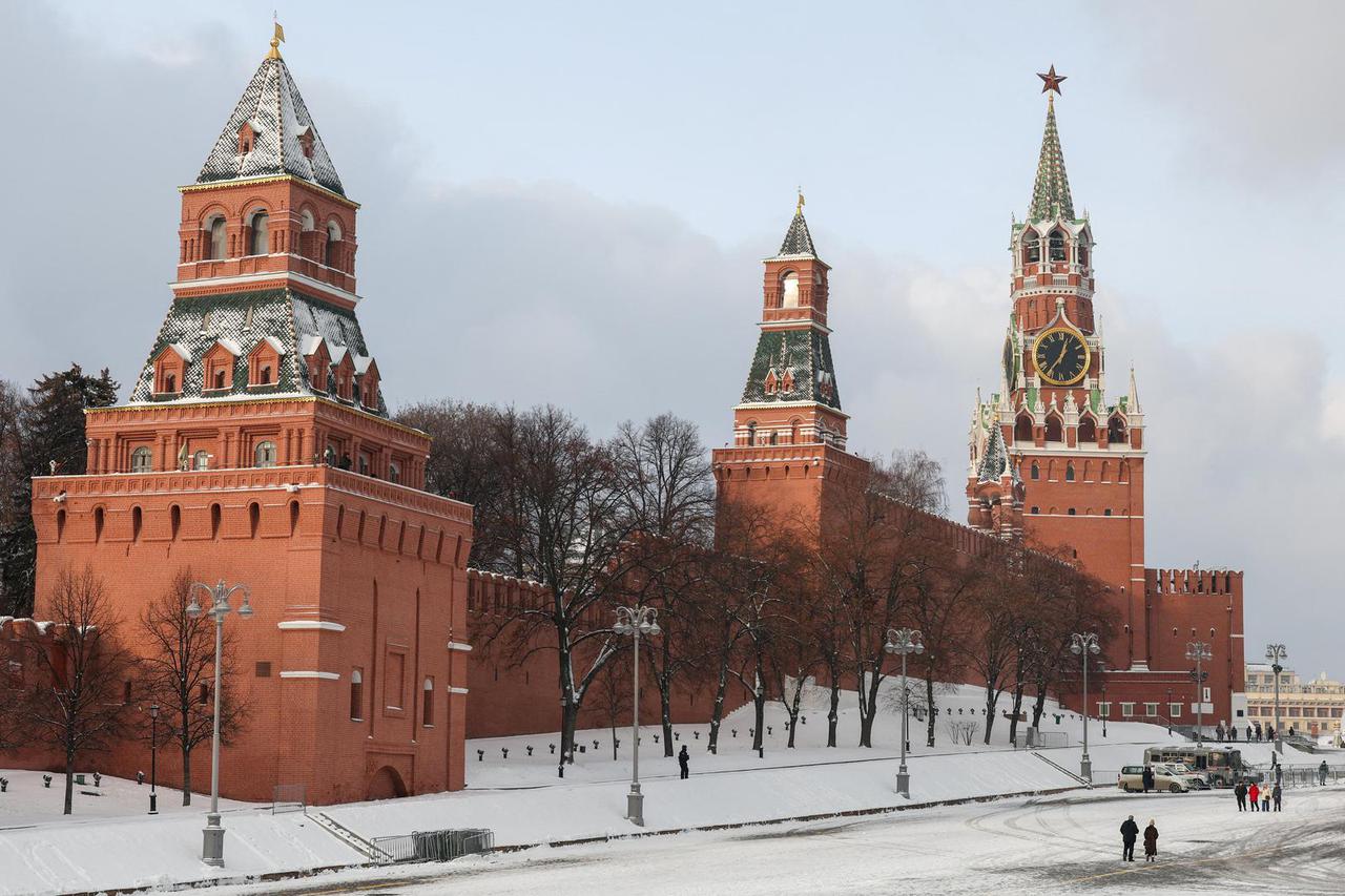 People walk near the Kremlin wall in central Moscow