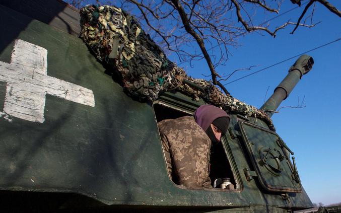 Ukrainian servicemen look on from 2S3 Akatsiya self-propelled howitzer at their position in a frontline in Donetsk region