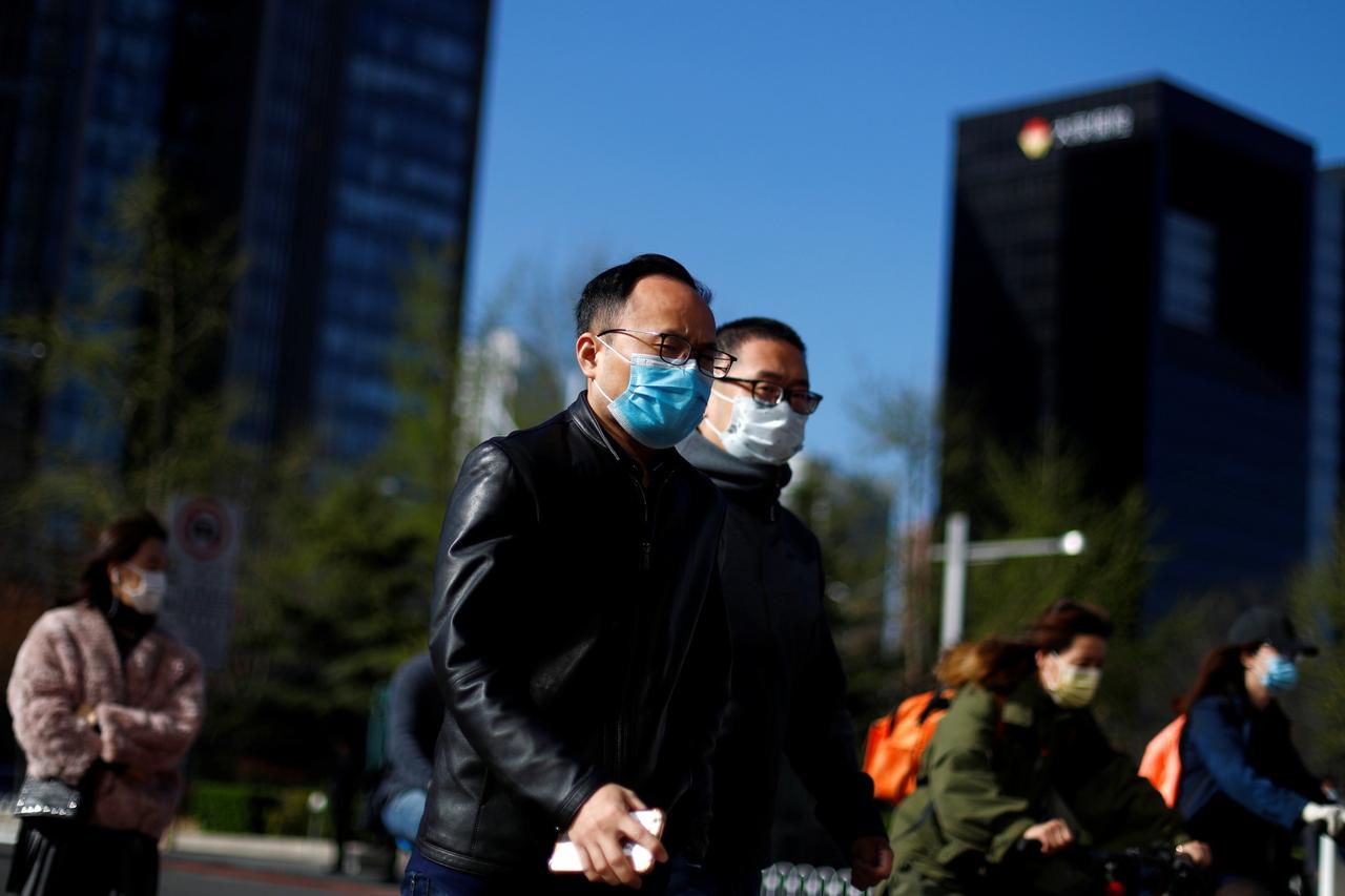 People wear masks as they head to work during morning rush hour amid the outbreak of  coronavirus disease (COVID-19) in Beijing