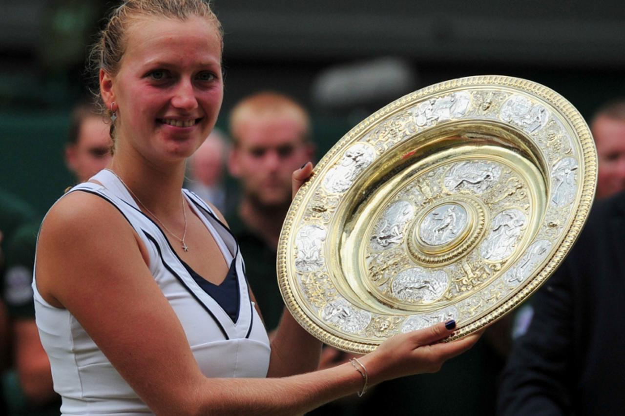 'Czech player Petra Kvitova poses for pictures with the trophy after beating Russia\'s Maria Sharapova in the Women\'s Final of the 2011 Wimbledon Championships at the All England Tennis Club, in sout