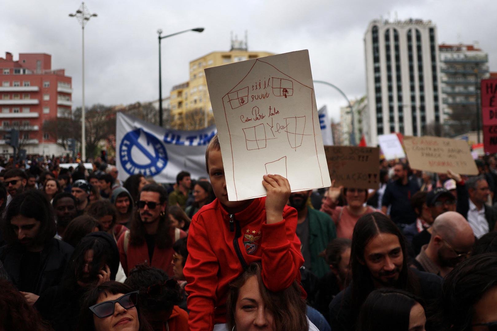 A child holds a drawing that reads: "House for everyone" during a protest for the right to affordable housing in Lisbon, Portugal, April 1, 2023. REUTERS/Pedro Nunes Photo: PEDRO NUNES/REUTERS