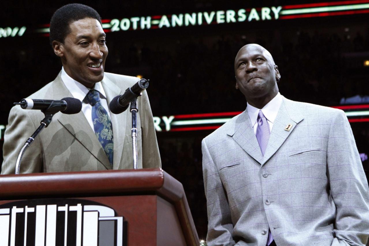 'Former Chicago Bulls star Scottie Pippen (L) talks to the crowd as Michael Jordan reacts during a ceremony to honor the 20th anniversary of their first world championship at half time of the NBA bask